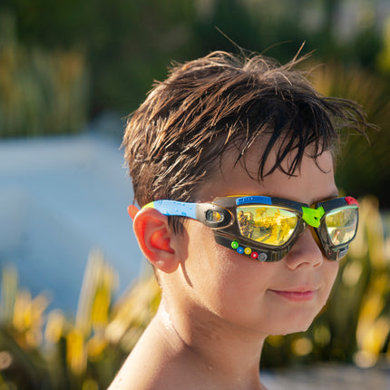 boy wearing gamer kids' swim goggles in jet black showing galaxy frame with gaming details and mirrored lens