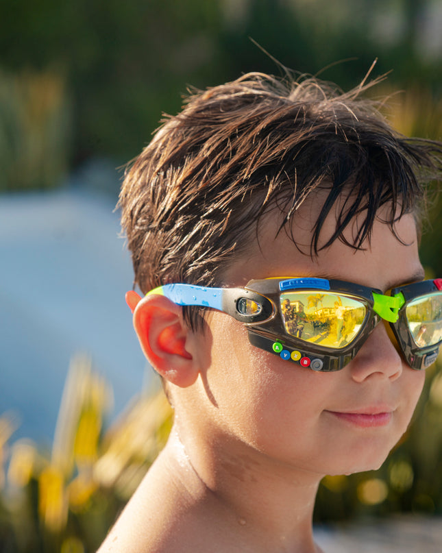boy wearing gamer kids' swim goggles in jet black showing galaxy frame with gaming details and mirrored lens