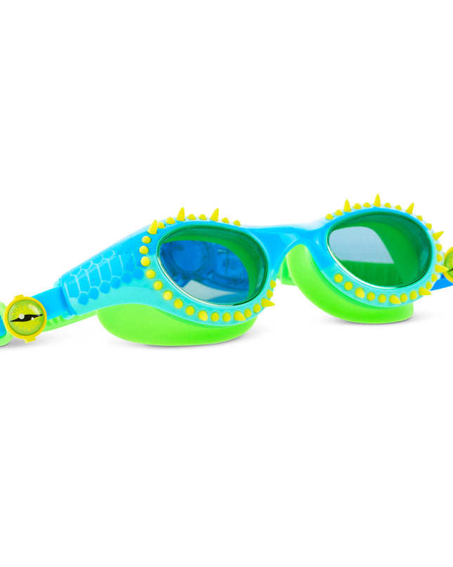 angled view of Jurassic Dive Kids Swim Goggles in stego splash showing silicone spikes, blue lenses, a reptilian printed frame and eyeball strap sliders