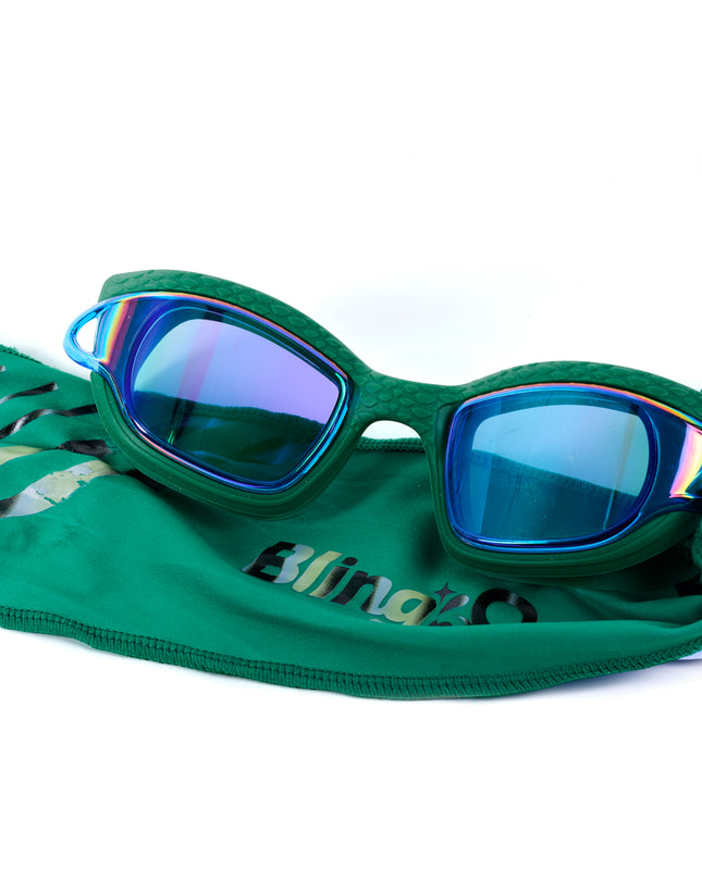 styled shot of Softline Swim Goggles in meadow showing textured frame, mirrored lens, and soft strap