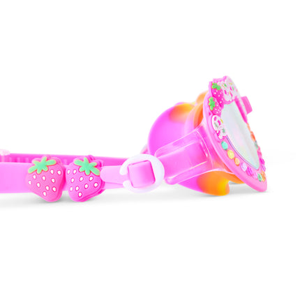 Close-up of Shortcake swim goggles in Strawberries & Cream showing strawberry sliders, gems and trim detail