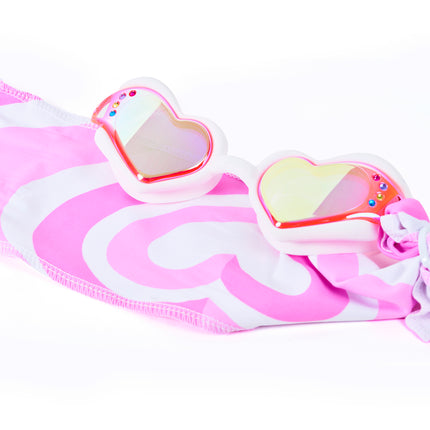 Close-up glam shot of Soft Crush Daydream goggles styled on heart soft strap, highlighting iridescent lenses, rhinestones, and easy-on soft strap