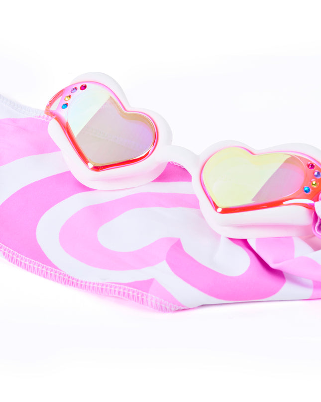 Close-up glam shot of Soft Crush Daydream goggles styled on heart soft strap, highlighting iridescent lenses, rhinestones, and easy-on soft strap