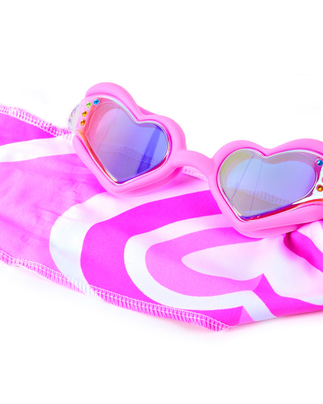 Close-up glam shot of Soft Crush Pink Wish goggles styled on heart soft strap, highlighting iridescent lenses, rhinestones, and easy-on soft strap