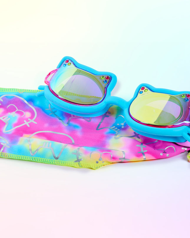 Close-up glam shot of Soft Paws Cozy Blue goggles styled on matching pastel tie-dye soft strap, highlighting mirrored lenses, rhinestones, cat frame shape, and easy-on soft strap