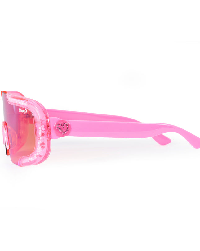 side product shot of pink sand kids' sunglasses in color sprinkle pink featuring shield frame with 3-d sprinkles in the frame, heart insignia and all pink frame and lens