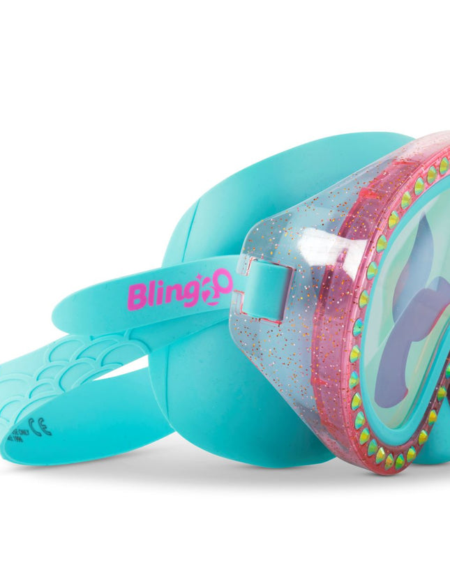 close-up of blue sea kids' swim mask with nose piece in blue sushi colorway showing reflective translucent mermaid tail print lens on rhinestone glitter frame