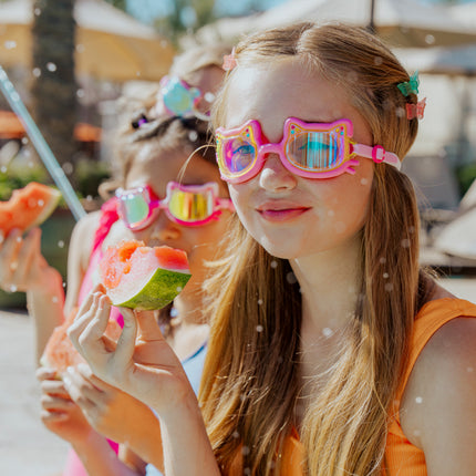 lifestyle of girl taking snack break next to pool in flexi feline kids swim goggles 