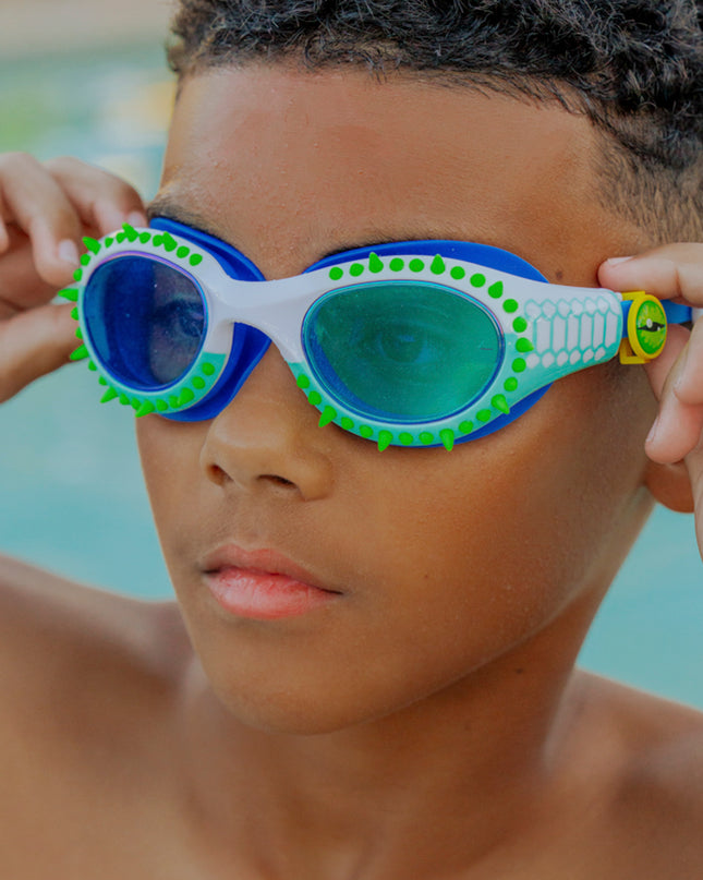 lifestyle of kid wearing jurassic dive in seafoam spike showing silicone spike and reptilian printed frame detail with eye ball slider