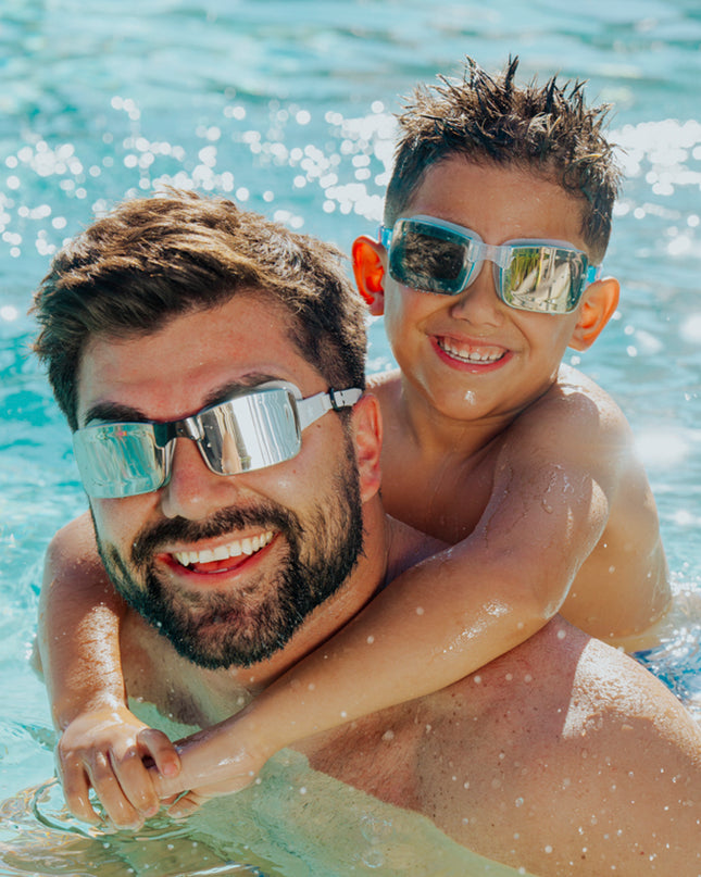 lifestyle image of dad and child both wearing velocity swim goggles 