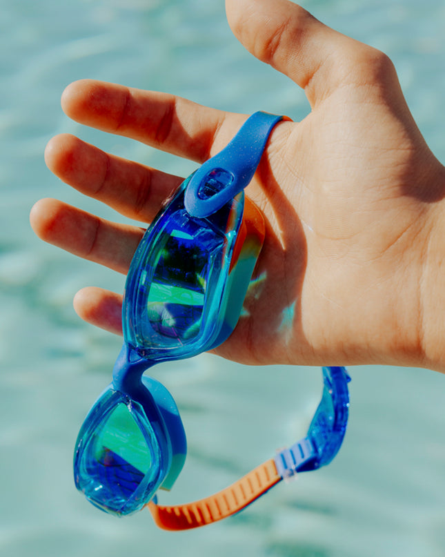 voyage swim goggles in trailblaze being held showing all silicone frame and tinted lens