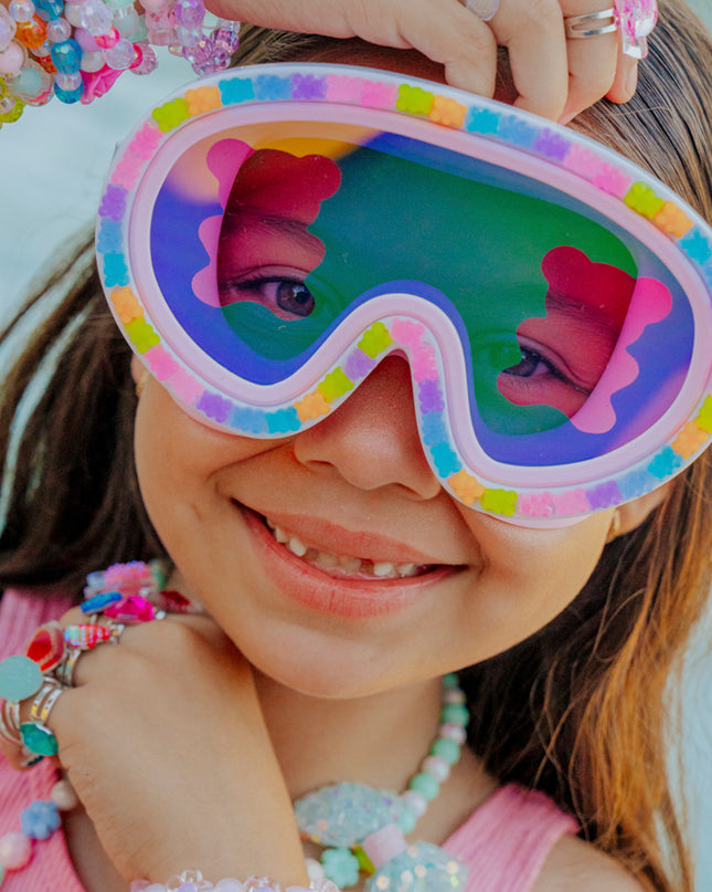 lifestyle image of child in charms, smiling and wearing candy cub swim mask showing 3D gummy bear detail and gummy bear lens
