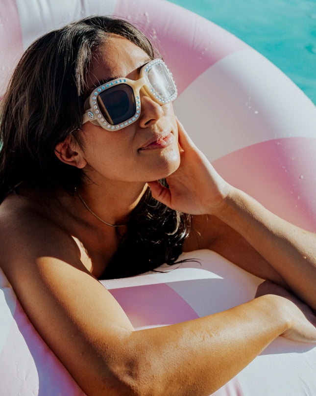 adult women swimming wearing bring vibrancy swim goggles in opal showing wide square framed swim goggles with rhinestones and tinted lens