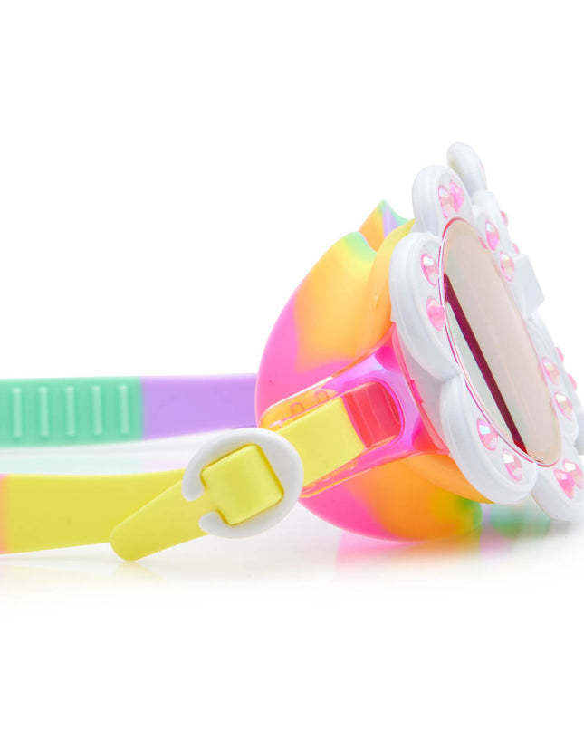 close-up view of dandi flower shaped swim goggles in sunlit sherry showing petal detail with rhinestone and bright rainbow colored strap and gasket 